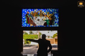 Silhouetted groom standing in a doorway in Guadalajara, giving directions to family members.